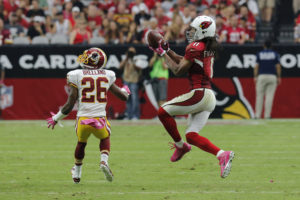 Arizona Cardinals wide receiver Larry Fitzgerald (11) pulls in a pass as Washington Redskins strong safety Bashaud Breeland (26) defends during the second half of an NFL football game, Sunday, Oct. 12, 2014, in Glendale, Ariz.(AP Photo/Rick Scuteri)
