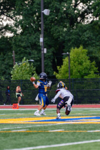 Senior quarterback Max Stovall prepares to launch the ball downfield with one hand, looking to make a play for Ballou.