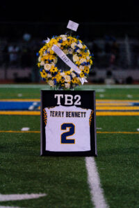 A memorial for Terry Bennett’s No. 2 jersey stands at midfield during Ballou’s halftime ceremony, surrounded by flowers in his memory. Photo courtesy of Ballou High School.